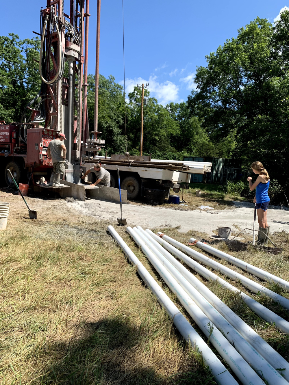  picture of grandpa, russ, and daughter working a well together